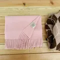Premium soft pink 100% Australian wool scarf with tassel detail on wooden surface - Baby Pink