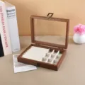 Detailed macro view of walnut wood jewelry box with glass lid and velvet compartments. - Wood Grain 9-Grid / 20x15x5cm