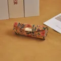 Floral cork lipstick gift box with elegant gold clasp on warm beige surface - Flower Sea Style / 8.5*3*3