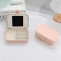 Pink PU leather jewelry box with internal mirror and velvet lining for travel storage. - Pink