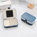 Portable blue PU leather jewelry box with mirror and multi-compartment storage for rings - Blue With White Trim
