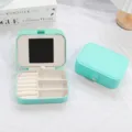 Elegant mint green PU leather jewelry box featuring a built-in mirror and ring storage slots - Teal Blue