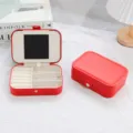 Compact red PU leather jewelry box with interior mirror and multi-grid storage tray - Red