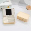 Portable PU leather jewelry box with mirror and compartments in elegant cream yellow - Gold
