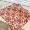 Close-up detail of a vintage red damask pattern cotton square scarf with scalloped edges - 68cm / Red Branch
