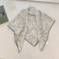 Detail view of the green botanical print and delicate lace trim on the cotton linen scarf - 68cm / Light Green Branches