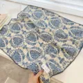 Close-up detail of a vintage blue floral cotton square scarf with black scalloped edges - 68cm / Light Blue Branches