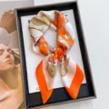 Elegant 70cm orange and white print faux silk square scarf for professional styling. - 70cmx70cm / Lily Of The Valley Rein - Orange Frame