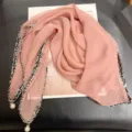 Elegant pink scarf detail showing the chic pearl pendant and stylish tweed border. - 68cm / Grapefruit Pink