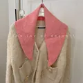 Detailed view of a soft pink wool knit triangle scarf styled with a cream cardigan - 81cm / Rose Pink