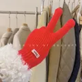Detail view of vibrant red knitted winter gloves with cozy white faux fur cuff trim. - One Size / New Year Red