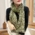 Green floral crinkle cotton linen scarf worn by a model in a natural setting - 繁花印花款 / Lush Floral Green / 175cm