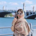 Model wearing a thick ethnic paisley shawl with tassels against a river bridge background - 65*200cm / Vintage Paisley-17