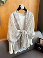 Detailed view of a bohemian patterned sun protection shawl featuring colorful fringe tassels. - Conch Flower