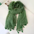 Detailed view of bohemian green floral scarf with tassel hem for resort sun protection - Fresh Green Small Flower