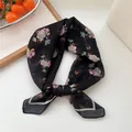 Retro black floral print square scarf tied as an elegant hair ribbon or versatile necktie - Black Lily Pattern