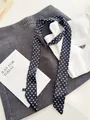 Gedetailleerd beeld van een zwarte skinny sjaal met witte stippen op grijze kleding - 140cm / Zwarte Polka Dots
