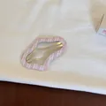 Détail d'une pince à cheveux BB en tissu vichy rose en forme de nuage sur tissu - Style Nuage Évidé / Carreaux Rose