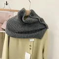 Close-up of a retro grey knitted neck warmer with large black buttons on a coat. - One Size / Dark Gray