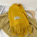 Elegant bright yellow imitation cashmere scarf with fringe detail and white woven patch - 38-180cm / Earthy Yellow