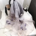 Close-up of silk wool scarf featuring delicate floral and butterfly embroidery details - Purple Grey