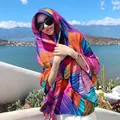 Vibrant ethnic multi-colored shawl scarf worn as a stylish headwrap for scenic travel photos - Multicolor