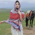 Ethnic style patterned shawl with tassels worn by a woman in a grassland setting - Ethnic Wave Pattern Red