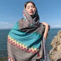 Asian model wearing a turquoise ethnic print sun protection shawl by the sea shore - Ethnic Wave Green