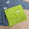 Premium soft lime green winter scarf featuring elegant tassel edges and brand label - Fruit Green