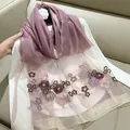 Close-up of elegant silk blend scarf featuring purple begonia flower embroidery detail. - 180cm / Dusty Pink
