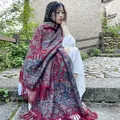 Detailed view of ethnic style paisley shawl with tassels worn in a rustic outdoor setting. - 65*200cm / Full Paisley Red