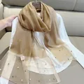 Close-up of elegant champagne imitation silk scarf with pearl beads on mesh ends - 180cm / Camel