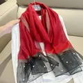 Detail of red and black silk-like scarf featuring elegant pearl accents and gold threads. - 180cm / Red and Black