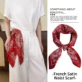 Detail showing a red retro paisley satin scarf used as a stylish waist belt on white trousers - 70cm / Bright Red Paisley Floral Style