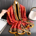Detailed view of luxury red and gold satin scarf with elegant traditional Chinese motifs - Fu Character on Red Background