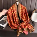 Detailed view of traditional red silk scarf featuring golden Chinese Fu character patterns - Full of Blessings