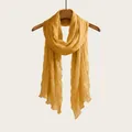 Mustard yellow long scarf with elegant crinkle texture displayed on a wooden hanger - 180cm / Turmeric