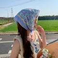 Elegant floral cotton linen headscarf detail worn by woman in outdoor sunny setting - Light Blue Grass
