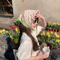 Asian model wearing the floral cotton linen headscarf in a sunny outdoor floral garden - Light Green Small Floral