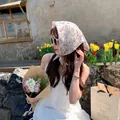Floral cotton linen headscarf worn by a woman in an outdoor garden setting - 58x58cm / Purple Flower