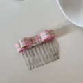 Detail view of a stylish pink checkered bow hair comb accessory for elegant hairstyles - Pink Gingham Bow Style (FJ83135)