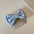 Detail view of a light blue satin double bow hair comb accessory with silver metal teeth - Blue Bow Hair Comb