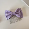 A high-quality detailed view of a elegant purple satin double-layered bow hair comb - Purple Bow Hair Comb