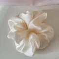 Detailed view of the soft mesh texture on an off-white oversized scrunchie - Beige