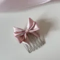 Exquisite detail shot of a sweet pink satin bow hair comb designed for girls styling - Pink Bow Comb