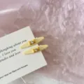 Detailed macro view of yellow duckbill hair clips with a cute bow and rhinestone - Bowknot Rhinestone Duckbill Clip / 2 Pcs/Set / Yellow