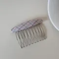 Detailed view of a plaid fabric covered metal hair side comb for women's bun hairstyle. - Pink Plaid Comb