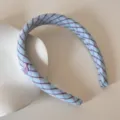 Detail view of a blue and purple plaid checkered headband with a sweet cherry charm. - Cherry Letter Headband / Blue Plaid