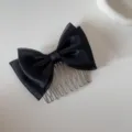 Detailed view of an elegant black mesh bow hair comb with silver metal teeth for hair styling - Mesh Bow - Comb / Black