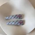 Close-up of blue and purple plaid hair clips with heart-shaped Sweety decoration - Cherry Letter Triangle Clip / 2PCS / Blue Plaid